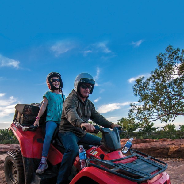 two people riding on the quad bike