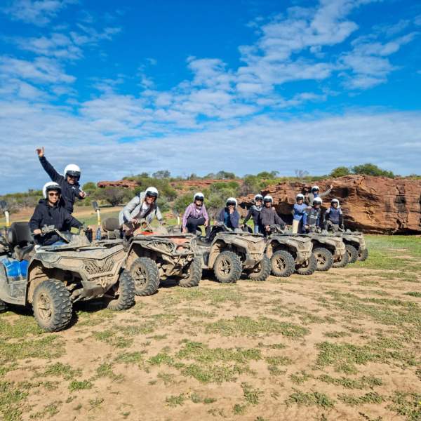 a man in a military vehicle on a dirt field