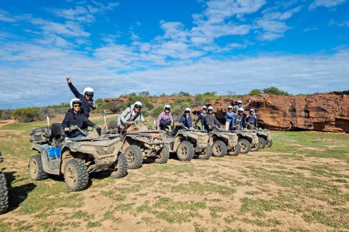 a man in a military vehicle on a dirt field