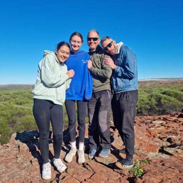 a group of people standing in a rocky area