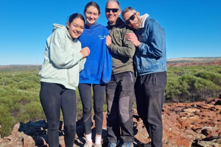 a group of people standing in a rocky area
