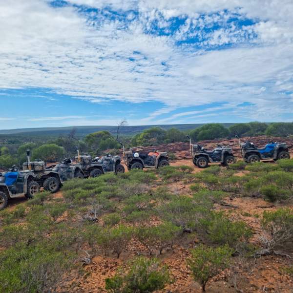 a motorcycle parked on the side of a dirt field