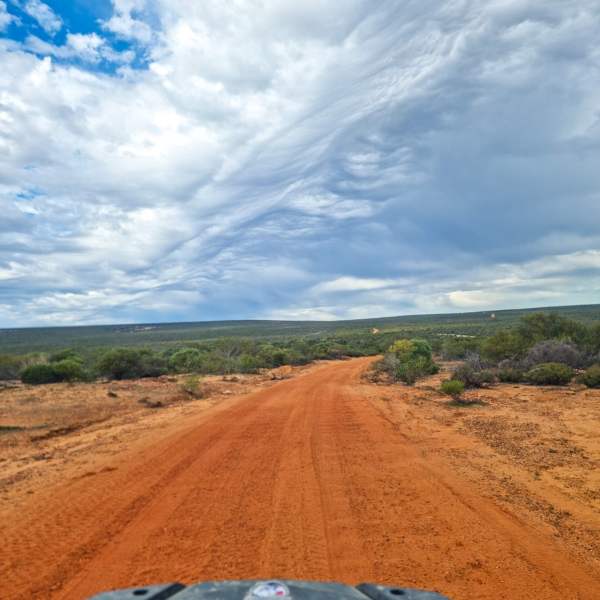 a car parked on the side of a dirt road