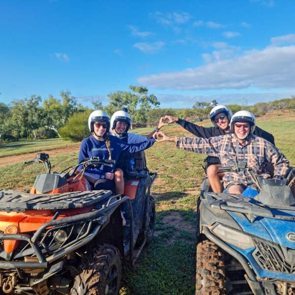 a group of people riding on the back of a bicycle