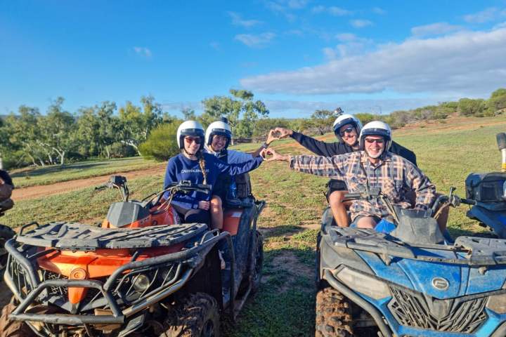 a group of people riding on the back of a bicycle