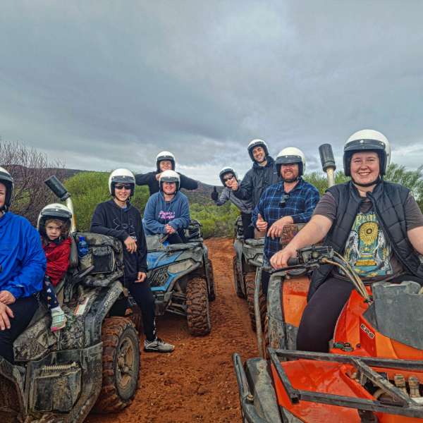 a group of people sitting on a motorcycle