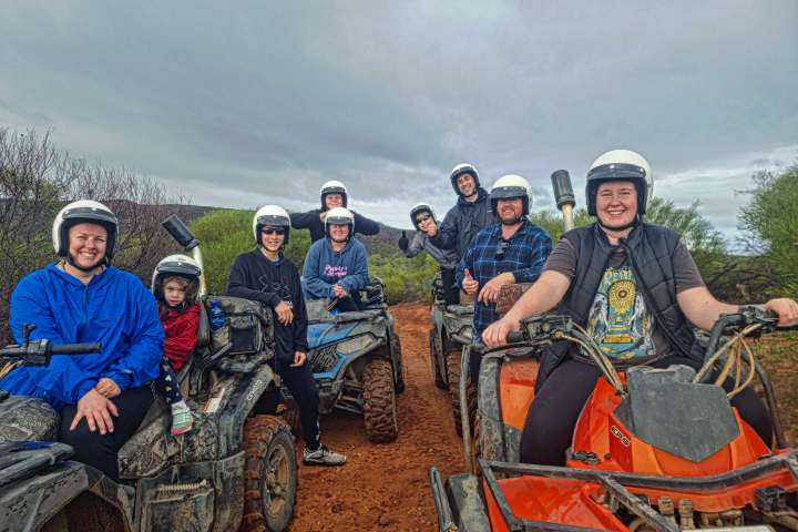 a group of people sitting on a motorcycle